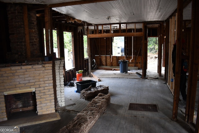 misc room with a brick fireplace and plenty of natural light