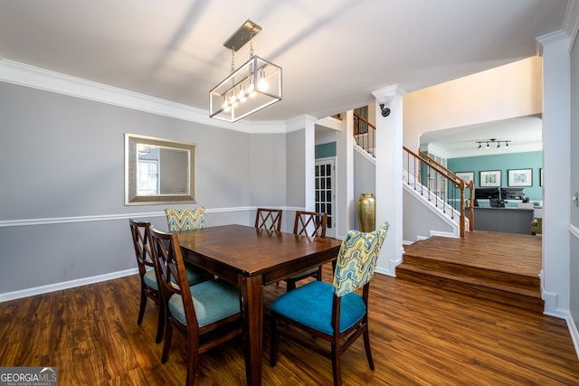 dining room featuring dark hardwood / wood-style floors and ornamental molding