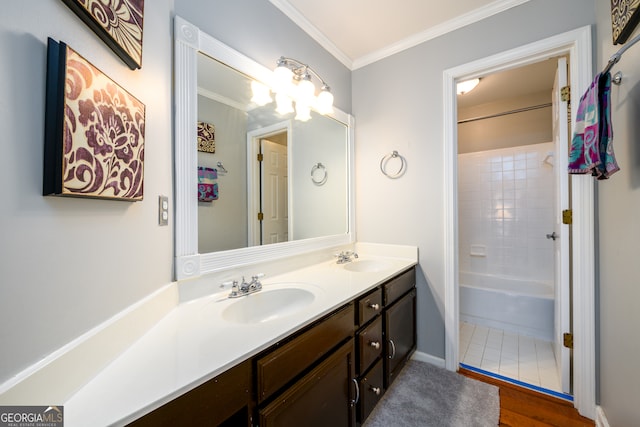 bathroom featuring hardwood / wood-style flooring, vanity, crown molding, and tiled shower / bath combo