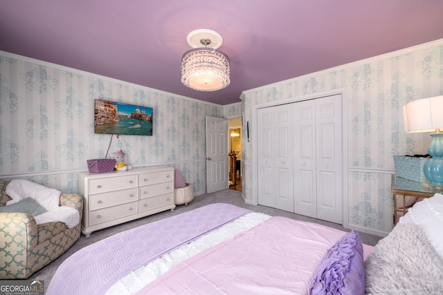 carpeted bedroom featuring crown molding and a closet