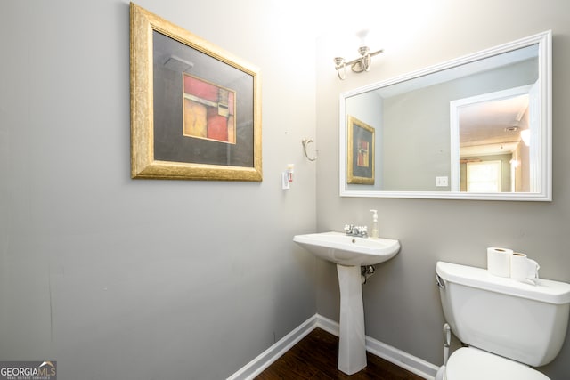 bathroom with wood-type flooring and toilet