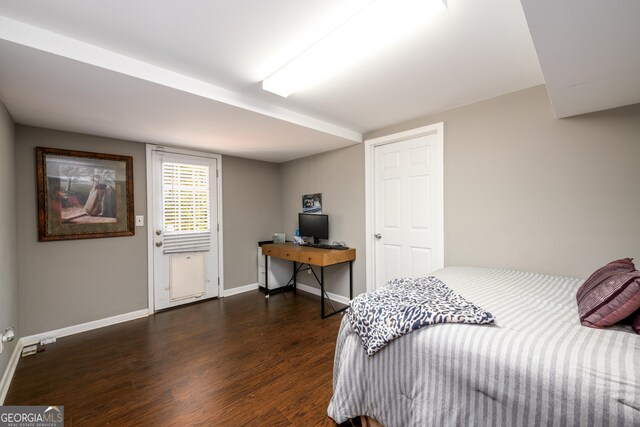 bedroom with dark hardwood / wood-style floors