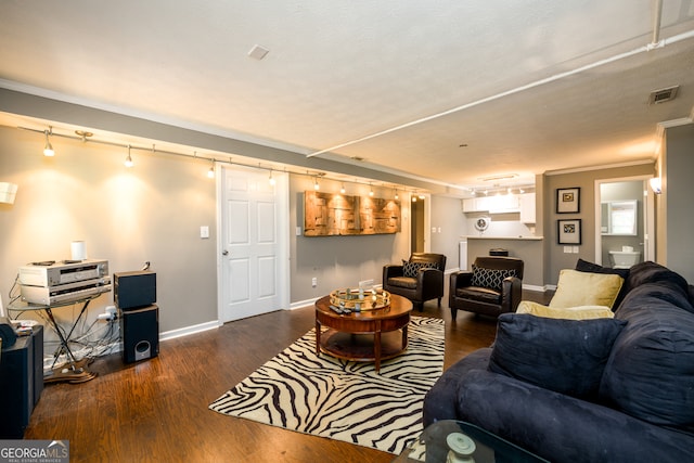 living room with a textured ceiling, dark hardwood / wood-style floors, and ornamental molding