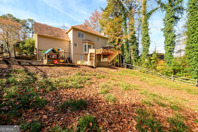 rear view of house featuring a wooden deck