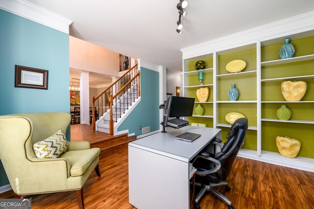 office area with crown molding, track lighting, and dark hardwood / wood-style floors