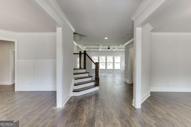 staircase featuring hardwood / wood-style floors, ceiling fan, and crown molding