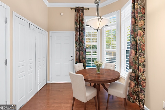 dining space with baseboards, dark wood-type flooring, and crown molding