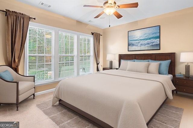 bedroom with a ceiling fan, baseboards, and visible vents