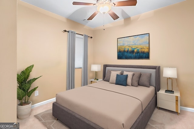 bedroom with baseboards, light colored carpet, and a ceiling fan