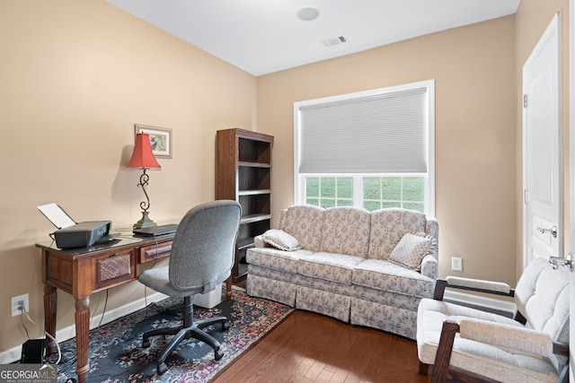 office area featuring visible vents, baseboards, and wood finished floors