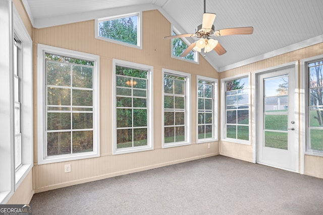 unfurnished sunroom with a ceiling fan and vaulted ceiling