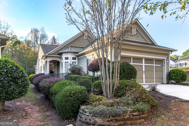 view of front of home with concrete driveway and a garage