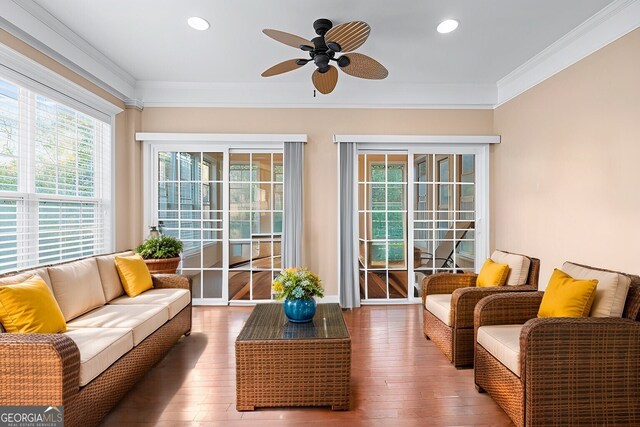 dining area featuring hardwood / wood-style flooring, crown molding, and decorative columns