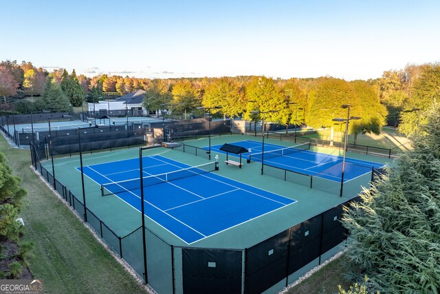 view of tennis court featuring fence