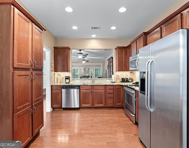 kitchen featuring a sink, visible vents, light wood-style floors, and appliances with stainless steel finishes