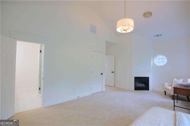 living area featuring light colored carpet and high vaulted ceiling