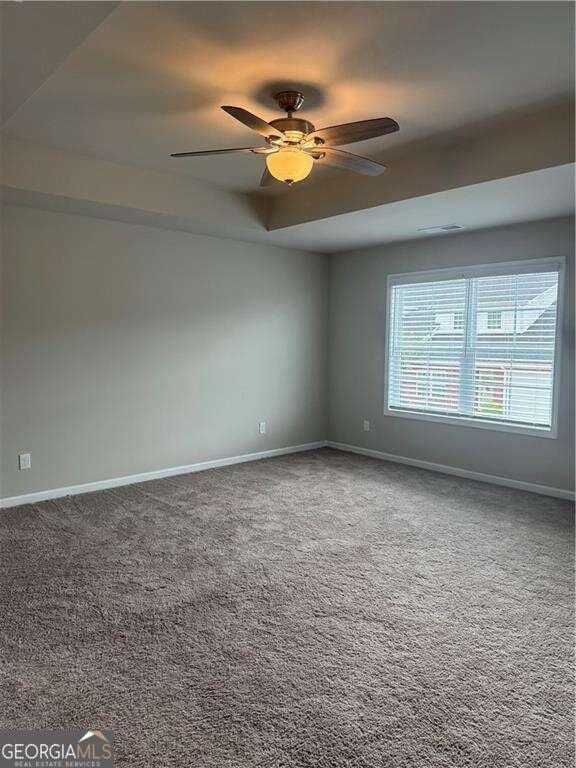 carpeted empty room with ceiling fan