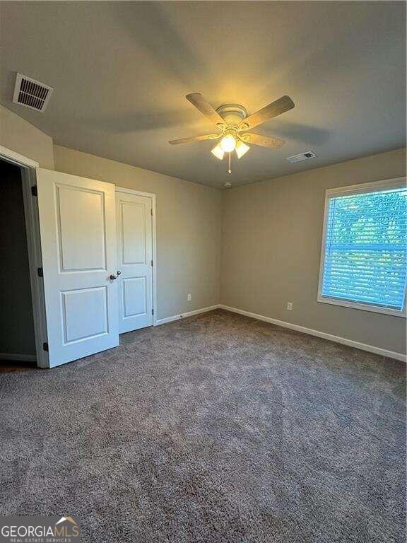 unfurnished bedroom with carpet and ceiling fan