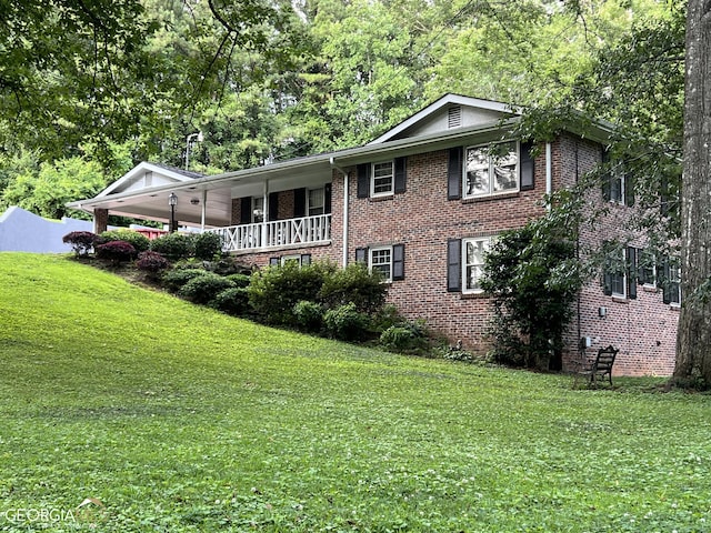 view of home's exterior featuring covered porch and a yard