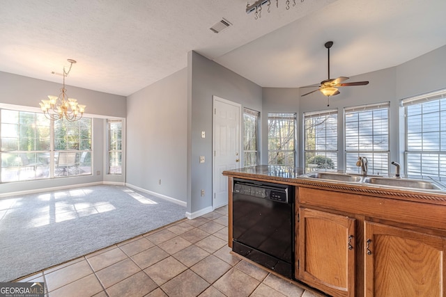 kitchen with dishwasher, ceiling fan with notable chandelier, sink, light tile patterned floors, and a textured ceiling