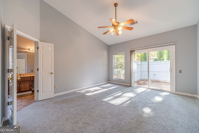 empty room featuring carpet, ceiling fan, and high vaulted ceiling