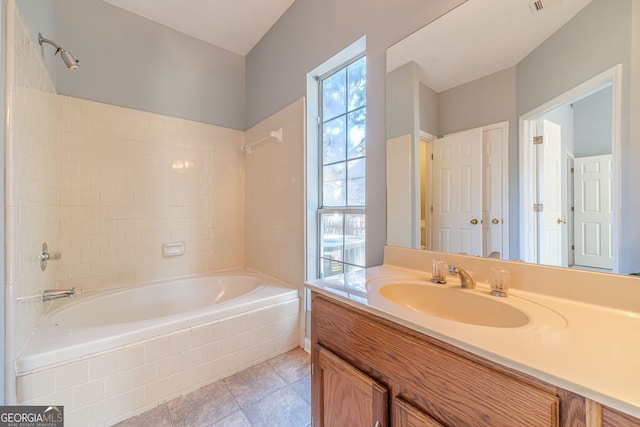 bathroom with vanity, tile patterned floors, and tiled shower / bath