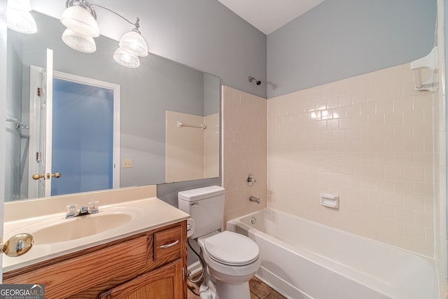 full bathroom with vanity, tiled shower / bath combo, toilet, and tile patterned flooring