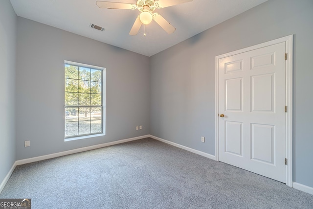 spare room featuring carpet floors and ceiling fan