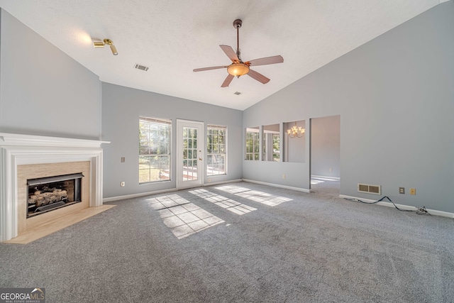 unfurnished living room with a textured ceiling, ceiling fan with notable chandelier, light carpet, and high vaulted ceiling