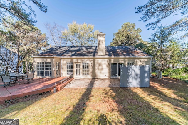 back of house featuring a yard and a deck