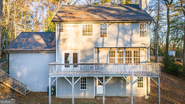 rear view of house featuring central AC, a wooden deck, and french doors