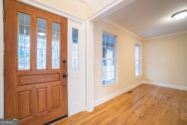 entryway featuring light hardwood / wood-style floors and ornamental molding