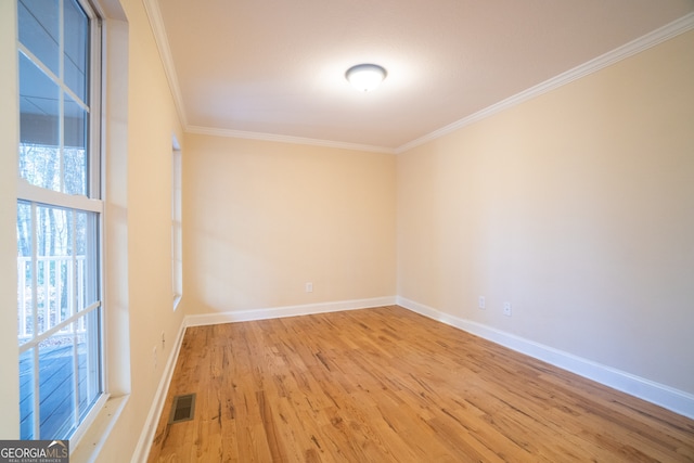 unfurnished room with crown molding and light hardwood / wood-style floors