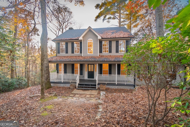 colonial-style house featuring covered porch