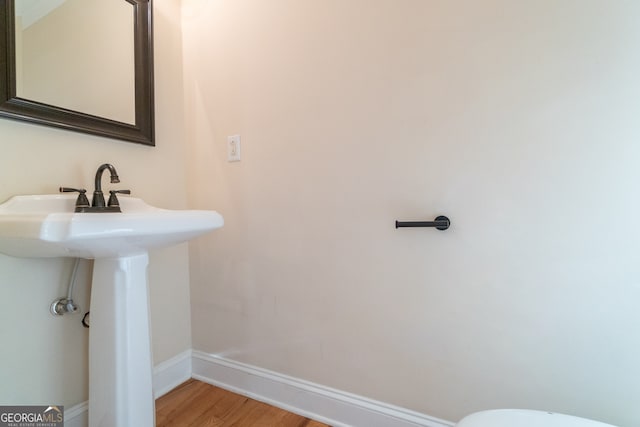 bathroom with hardwood / wood-style floors