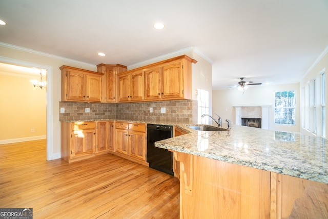 kitchen featuring kitchen peninsula, backsplash, sink, black dishwasher, and light hardwood / wood-style floors