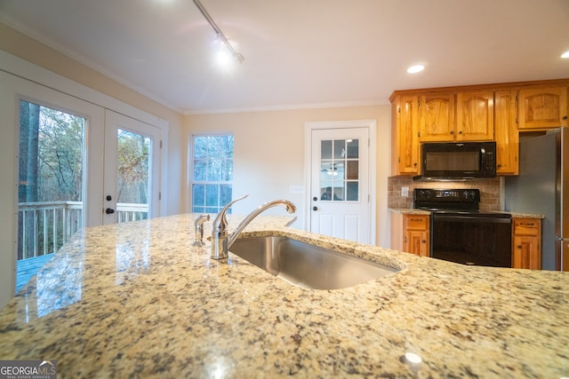 kitchen with crown molding, decorative backsplash, sink, and black appliances