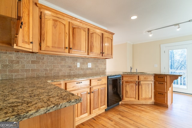 kitchen with kitchen peninsula, decorative backsplash, light wood-type flooring, sink, and black dishwasher