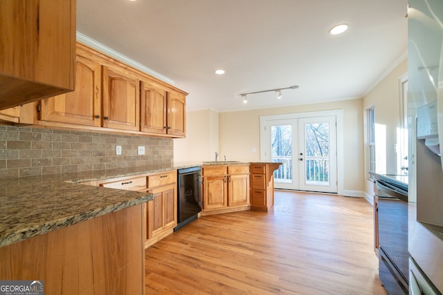 kitchen featuring kitchen peninsula, french doors, light wood-type flooring, light stone countertops, and black dishwasher