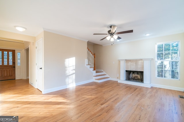 unfurnished living room with crown molding, light hardwood / wood-style flooring, and ceiling fan