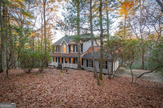 colonial inspired home featuring a porch