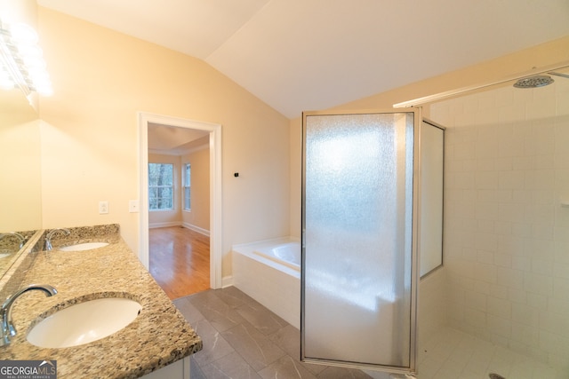 bathroom featuring hardwood / wood-style floors, vanity, lofted ceiling, and shower with separate bathtub