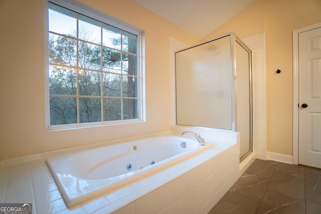 bathroom with tile patterned flooring, lofted ceiling, and independent shower and bath