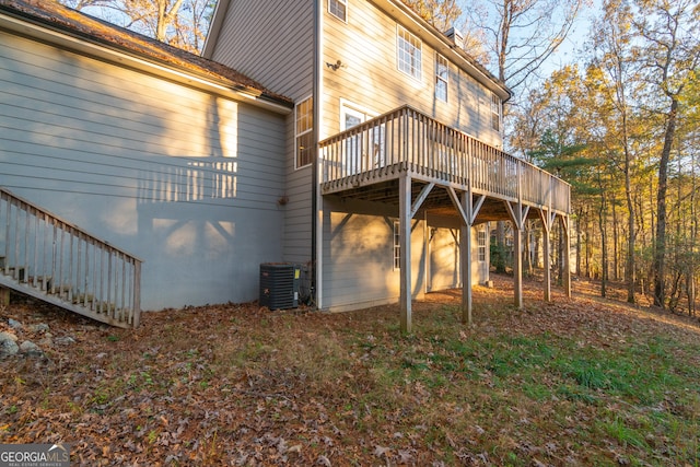 view of side of property with central AC and a deck