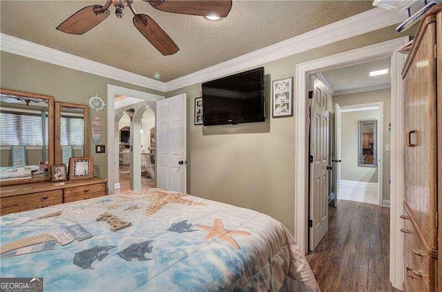 bedroom featuring a textured ceiling, ceiling fan, ornamental molding, and dark wood-type flooring