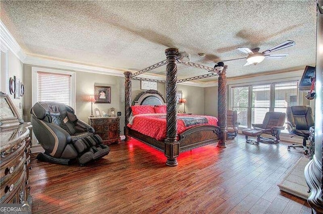 bedroom with hardwood / wood-style floors, ceiling fan, a textured ceiling, and multiple windows