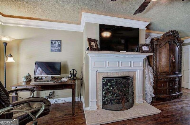 interior space with ornamental molding, a textured ceiling, ceiling fan, a tile fireplace, and wood-type flooring