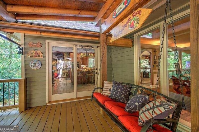 sunroom / solarium featuring beam ceiling