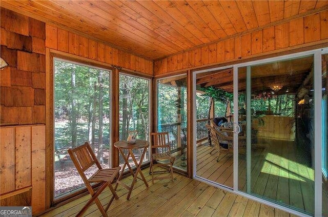 unfurnished sunroom with wooden ceiling