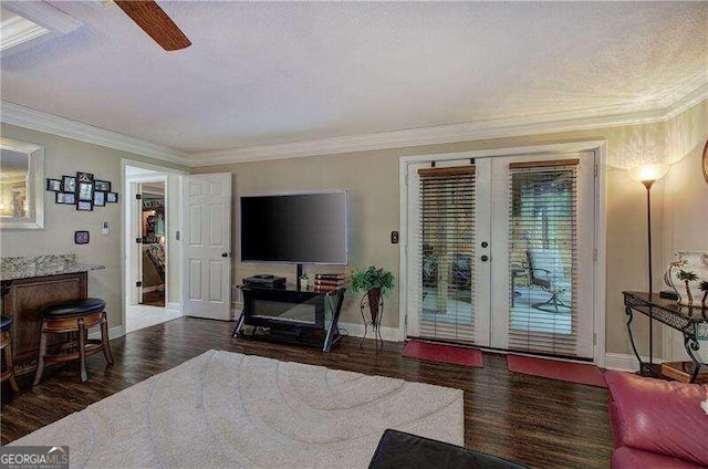 living room featuring ceiling fan, french doors, dark hardwood / wood-style floors, and ornamental molding